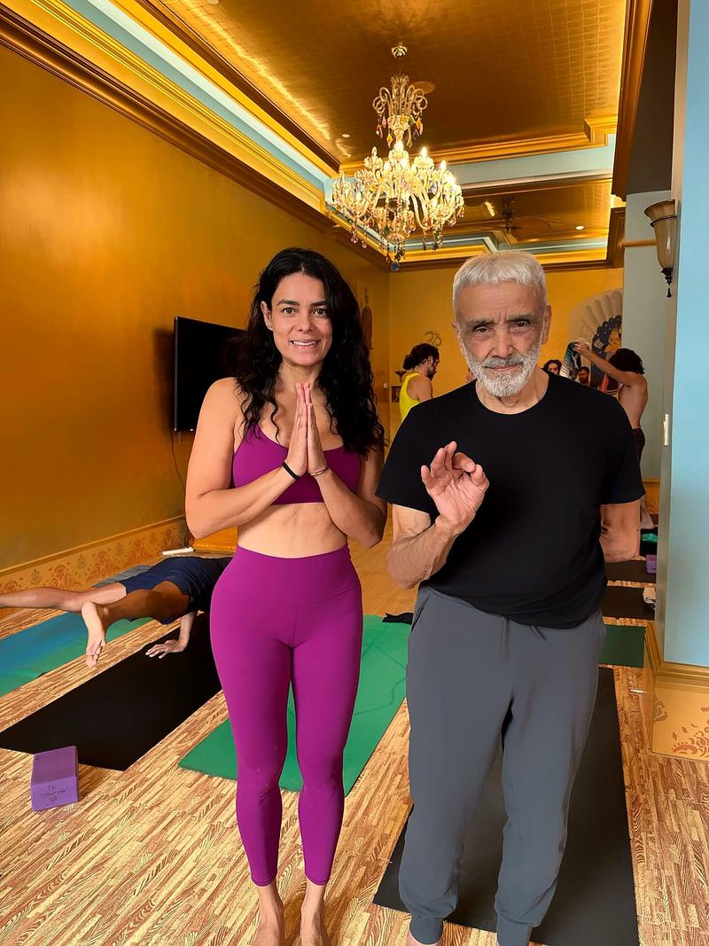 Pamela in namaste with her teacher
