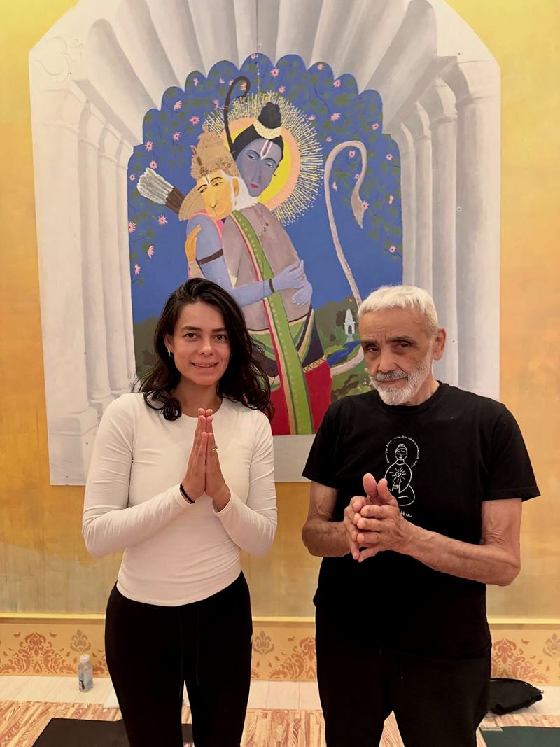 Pamela and her teacher before a mural